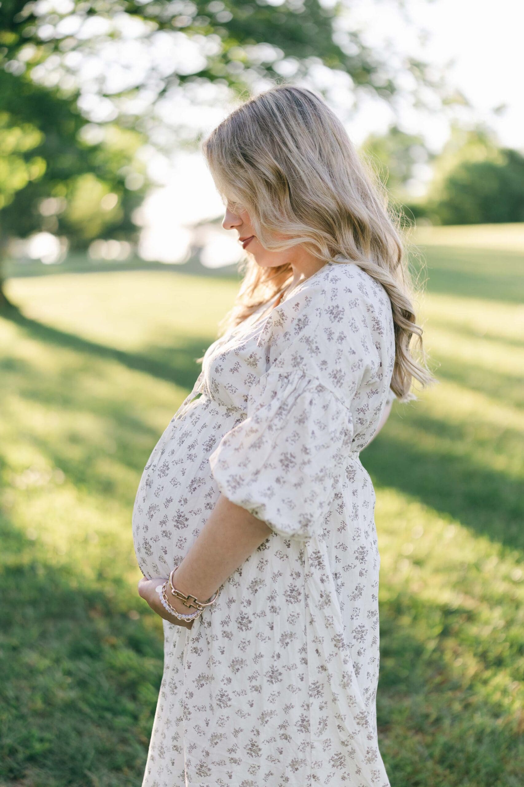 Pregnant mother holding her belly at her spring maternity session in Johnson City